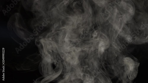 White smoke on a black background in slow motion