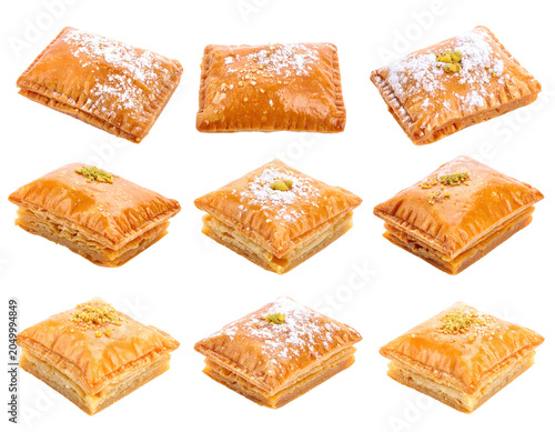 Nine Golden Baked Baklava Pastries Sprinkled With Powdered Sugar and Pistachios on Transparent Background