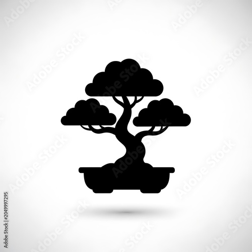 Black silhouette of blooming tree against white background.