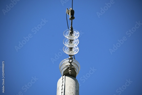 Utility Pole with Power Lines Against Blue Sky
