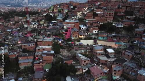 The infamous Comuna 13 hillside neighborhood in Medellin, Colombia, Evening Zoom out Aerial View of Skyline