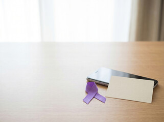 Purple Awareness Ribbon and Smartphone on Minimal Wooden Desk