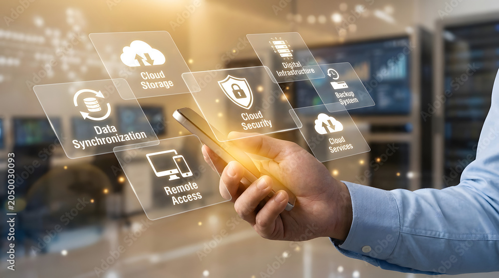 Obraz premium Cloud computing and data security concept with hand holding smartphone and holographic digital infrastructure icons in a blurred server room background