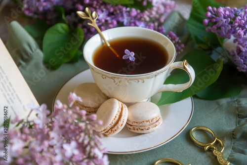 Bilde på lerret Spring flowers lilac, jasmine, bird cherry, rose hips, roses, peonies, poppies and lilies of the valley, tea and coffee in beautiful porcelain and ceramics