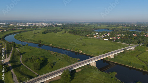 Εκτύπωση καμβά Aerial view of a modern concrete road bridge over a winding river