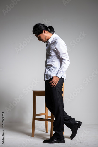 Foto Studio portrait of a handsome Asian man with long hair.