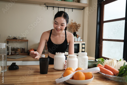 Young woman preparing protein shake for healthy nutrition