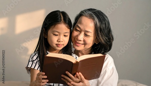 Grandma reads to girl.