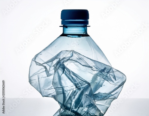 crumpled mineral water plastic bottle isolated on white background