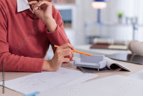 furniture designer architect working with architectural model blueprint drawing design planning interior space at home office studio creative workspace