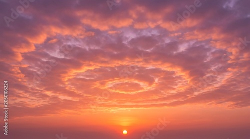 Atmospheric Sunset Sky Background with Beautiful Spiral Cloud Patterns and Warm Sun Glow
