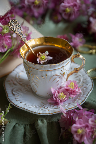 Spring flowers lilac, jasmine, bird cherry, rose hips, roses, peonies, poppies and lilies of the valley, tea and coffee in beautiful porcelain and ceramics.