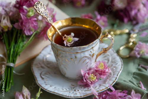 Spring flowers lilac, jasmine, bird cherry, rose hips, roses, peonies, poppies and lilies of the valley, tea and coffee in beautiful porcelain and ceramics.