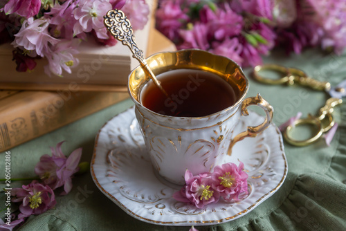 Spring flowers lilac, jasmine, bird cherry, rose hips, roses, peonies, poppies and lilies of the valley, tea and coffee in beautiful porcelain and ceramics.