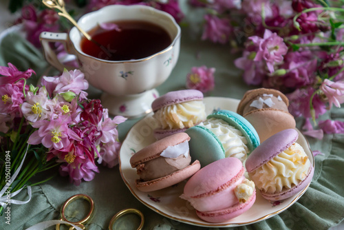 Spring flowers lilac, jasmine, bird cherry, rose hips, roses, peonies, poppies and lilies of the valley, tea and coffee in beautiful porcelain and ceramics.