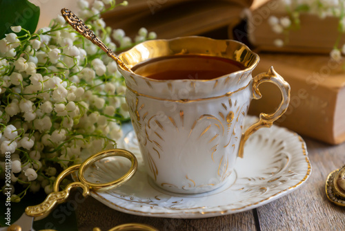 Spring flowers lilac, jasmine, bird cherry, rose hips, roses, peonies, poppies and lilies of the valley, tea and coffee in beautiful porcelain and ceramics.