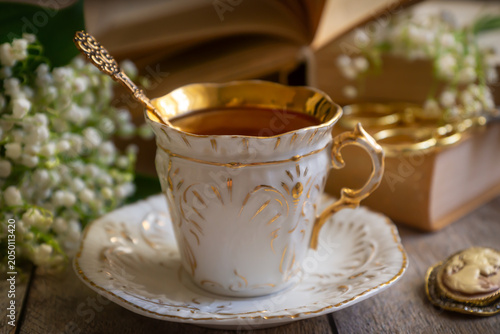 Spring flowers lilac, jasmine, bird cherry, rose hips, roses, peonies, poppies and lilies of the valley, tea and coffee in beautiful porcelain and ceramics.