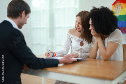 Fotografie Married couple sits affectionately expressing their love and goodwill towards each other transgender woman and handsome foreign man sit holding hands gently demonstrating equality