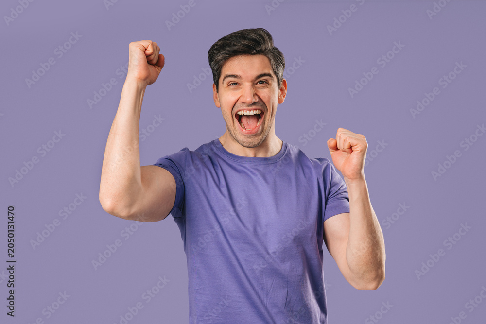 Fototapeta premium Handsome Surprised Man With Triumph Yes Victory Gesture. Jackpot, Win, Success.