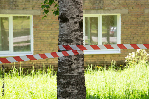 Incident site. Crime. Red and white barrier tape.