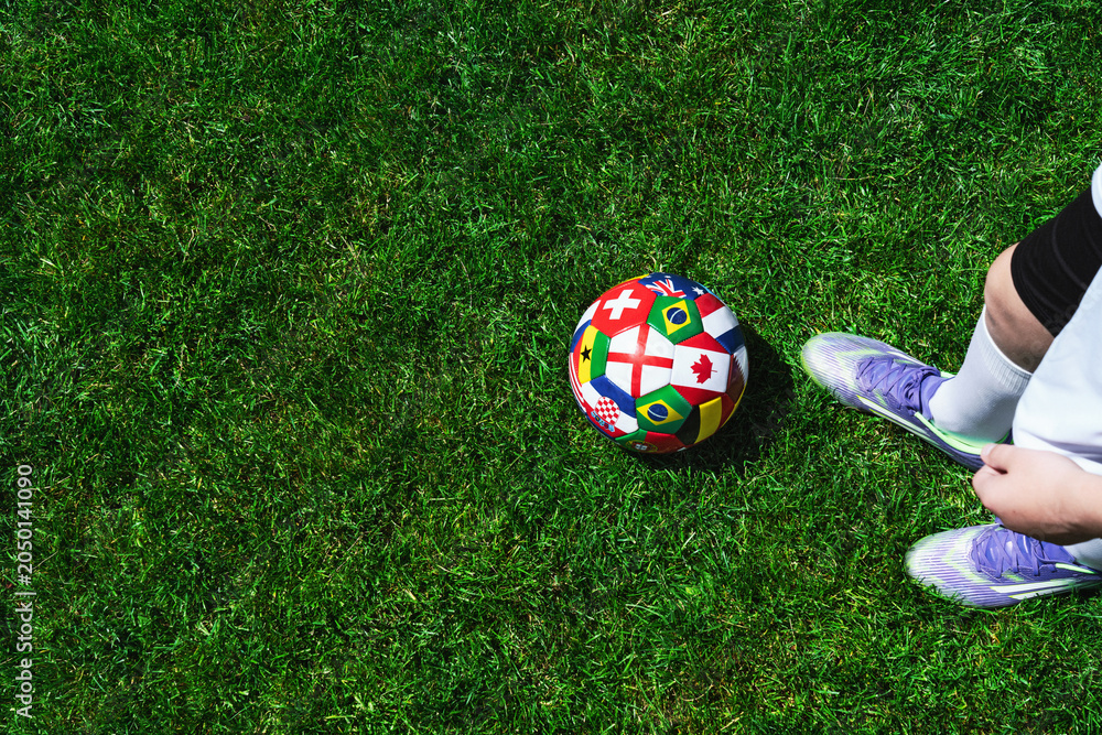 Naklejka premium Feet of soccer player step on soccer ball for kick off in stadium