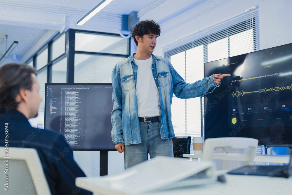 Fototapeta premium Businessman presenting voice AI software on screen to diverse team for sales report marketing campaign tech startup creative collaboration strategy hybrid workspace office background