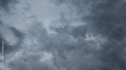 Timelapse of blue-gray evening clouds moving across a blue sky

