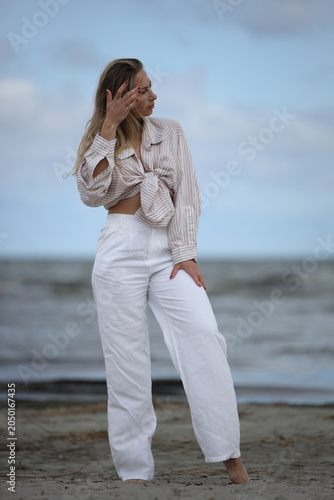 Young Woman Posing on Beach in Striped Shirt