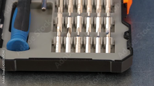 A set of metal bits for installation work in a plastic case.