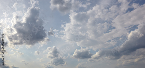Panoramic photo of blurred sky. Blue sky background with cumulus clouds