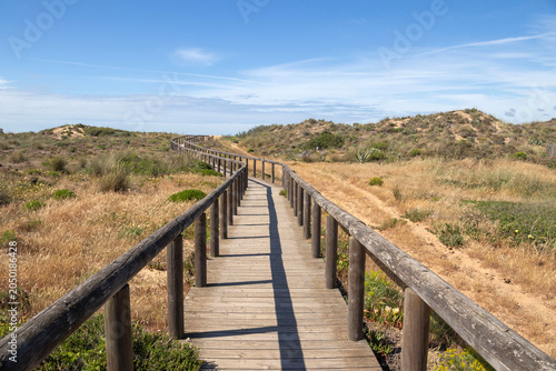 Wooden walkway leading to Bordeira Beach, Algarve, Portugal