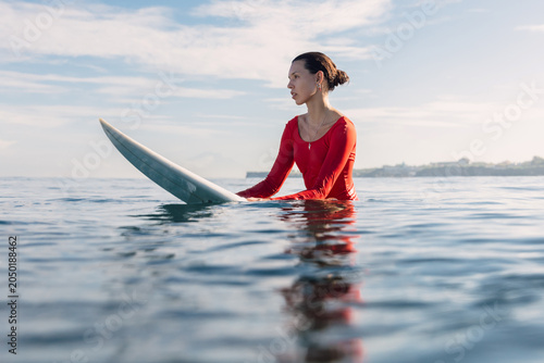 Photography Surfer woman on surfboard in ocean. Surfer woman in water