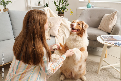Young woman holding paws of...