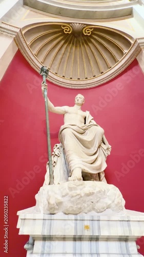 Ancient Greek and Roman marble sculptures displayed in ornate museum gallery