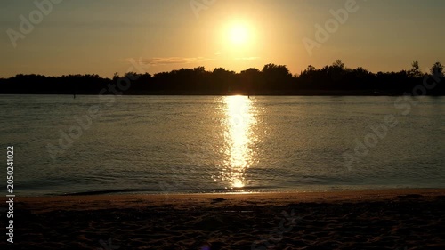 Sunset Over Calm River With Sandy Beach
