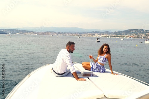 a young couple on the edge of a yacht