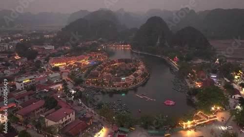 Aerial view of Tam Coc, a Historic Old Town Island in evening, Surrounded by Carst Mountains in Ninh Binh, Vietnam.