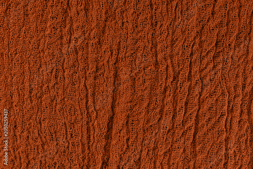 Fotografie Vertical rust orange crinkled fabric texture with woven thread pattern and warm