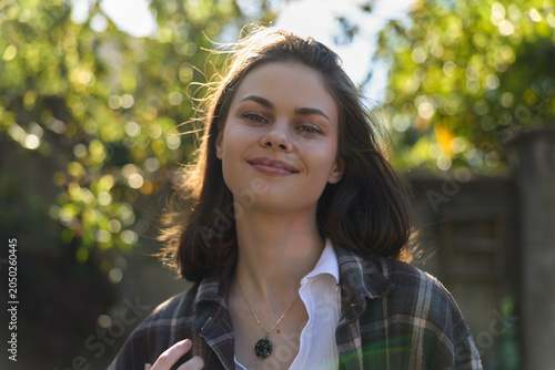 Slika na platnu Smiling woman outdoors in daylight wearing casual outfit, enjoying a sunny lifes