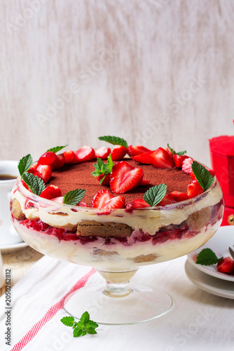Strawberry Tiramisu Trifle Dessert with Cream Layers and Mint in Glass Bowl
