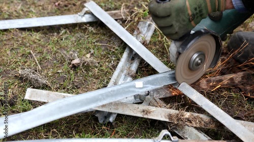 A specialist cuts metal with a special saw.