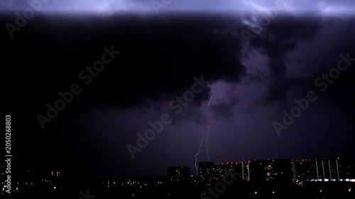 A severe thunderstorm in a black sky. A hurricane and lightning in the night sky.