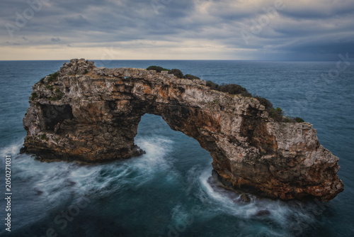 Tableau sur toile Natural arch formation on Mallorca Island observed at dusk, geological preservation, also known like Mirador de Es Pontas