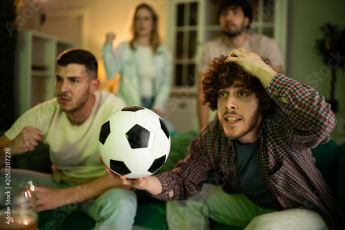 Quadro em tela Friends reacting to disappointing football game watching television