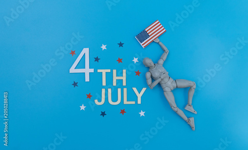 Mannequin holding american flag celebrating fourth of july