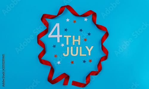 4th of july text with red ribbon and stars on a blue background