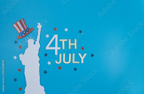 Statue of liberty holding uncle sam hat celebrating fourth of july