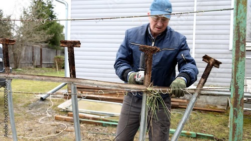 A construction worker cuts metal into pieces. A worker cuts metal into pieces with a special saw.