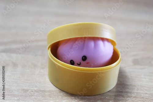 A small anti-stress toy squishy in the shape of a dumpling is in a box