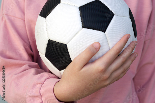 Person holding a soccer ball in a hand